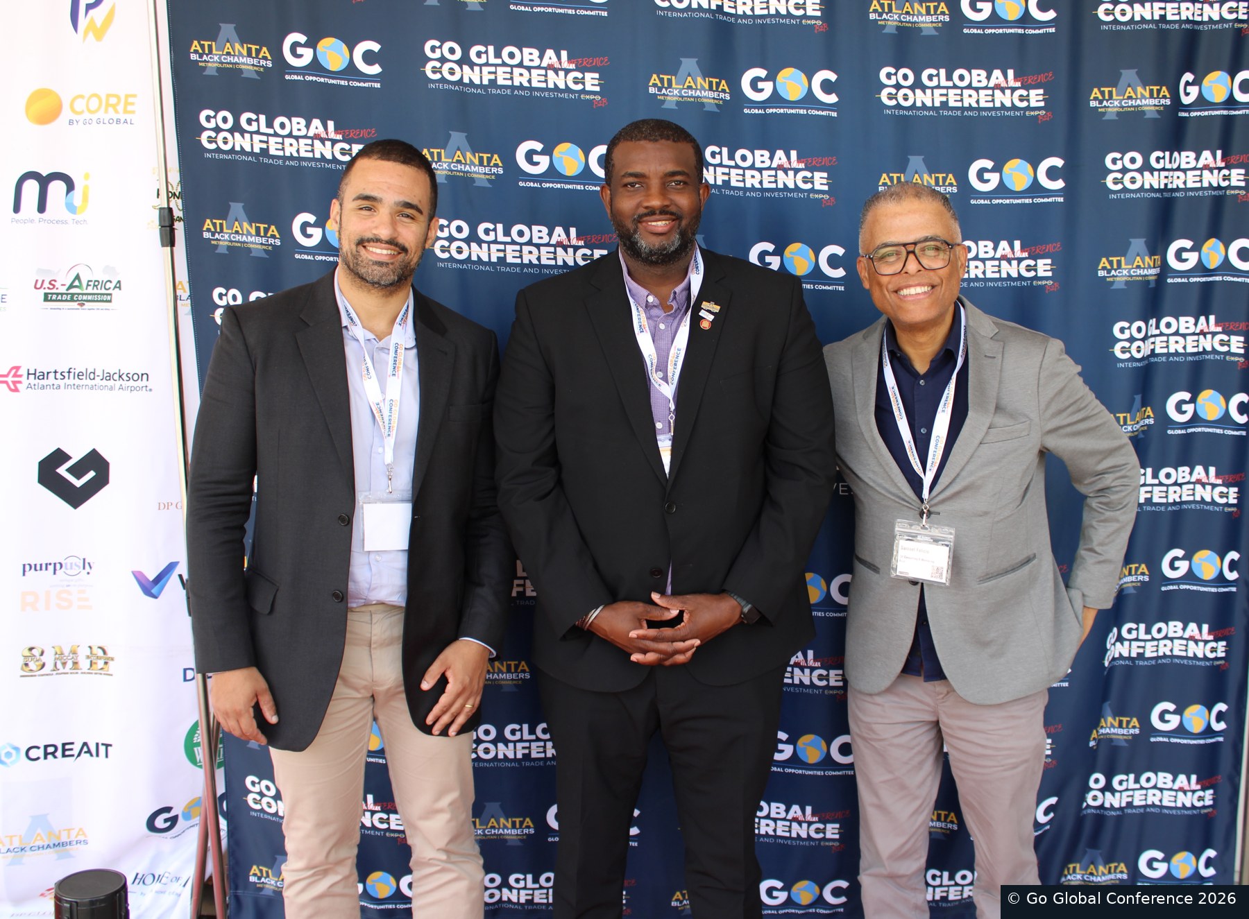 Delegates together at the Go Global Conference backdrop · GGC 2026