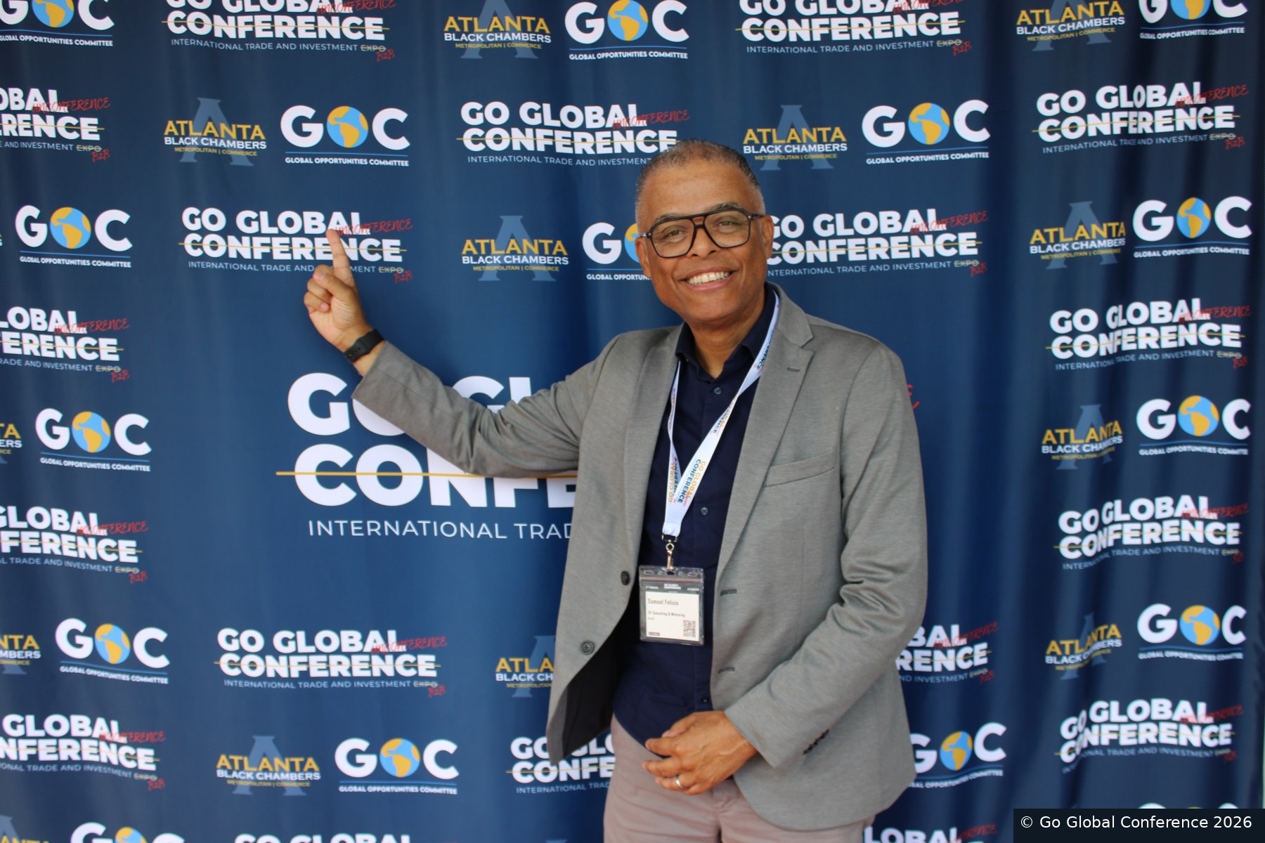 Delegate portrait against the Go Global Conference backdrop · GGC 2026